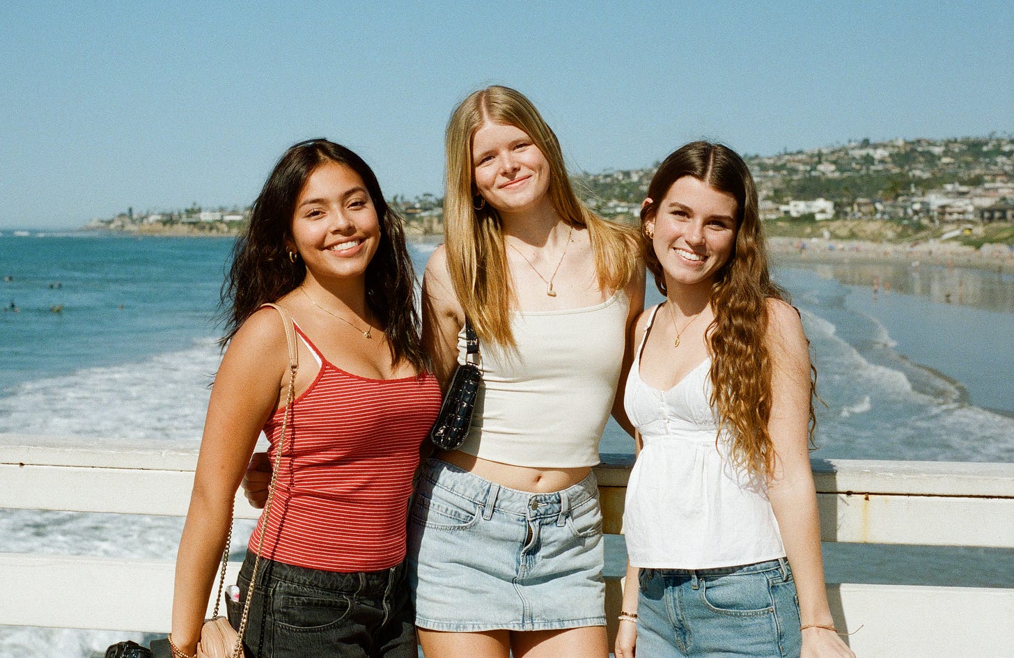 Three girlfriends posing on the pier in Pacific Beach. 