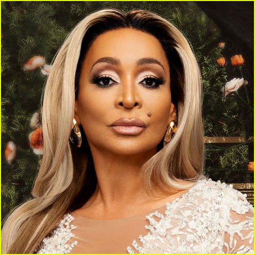 Portrait of Karen Huger from The Real Housewives of Potomac, wearing a glamorous outfit with soft makeup and long blonde hair.