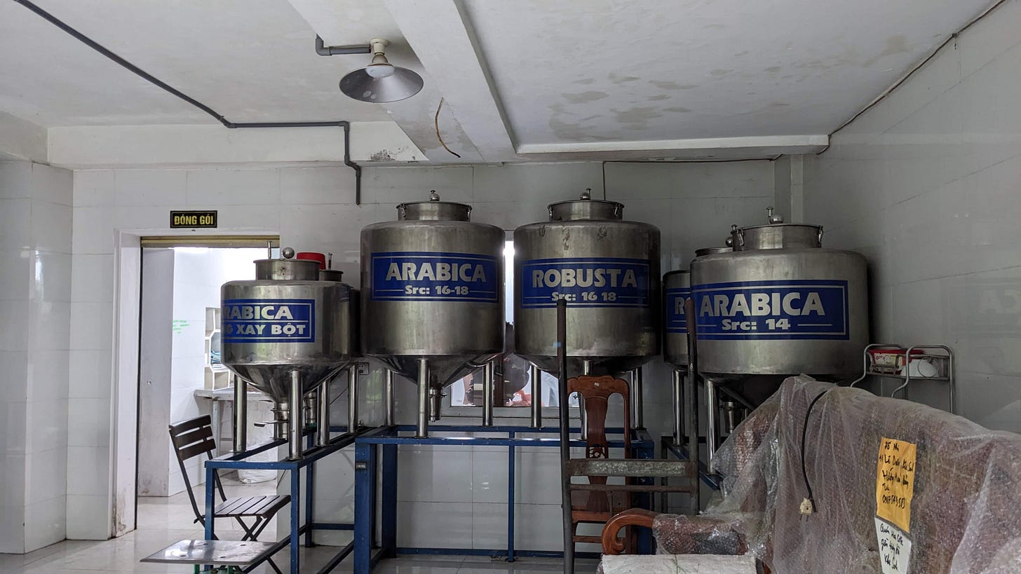 large containers of coffee at a roastery