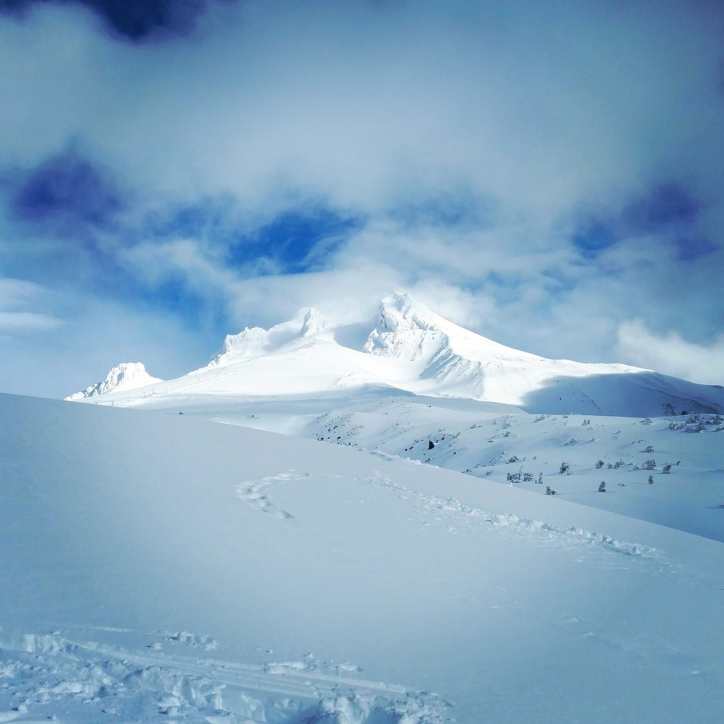 a snowy mountain against a blue sky