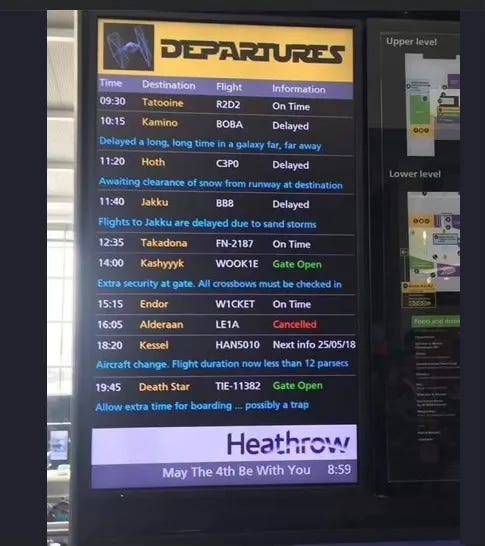 A “Departures” sign with a flight schedule that lists destinations like Tattooine and Death Star.At the bottom, “May The 4th Be with You.”