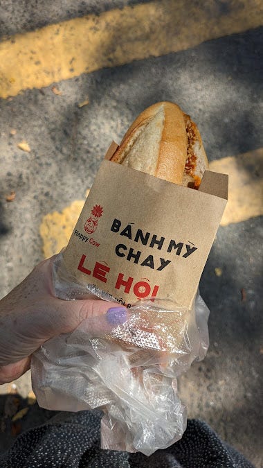 banh mi held in hand, and one opened up