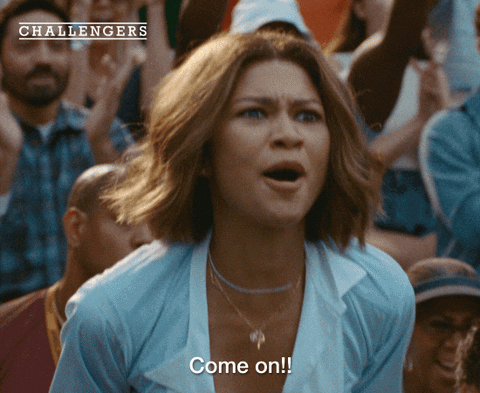 An older Tashi Duncan screaming "come on!" watching a tennis match.