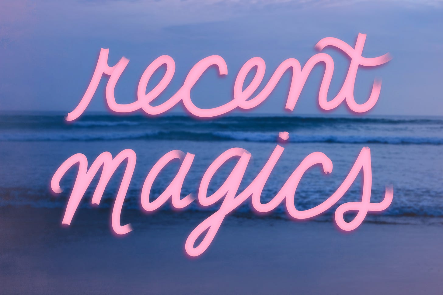 Blue-tinted photograph of waves rolling in to a beach. Pink script scrawled on the image reads "recent magics."
