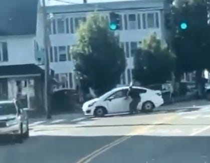 This clip from a video shot by an eyewitness shows an ICE Agent running alongside a car they were attempting to stop in Biddeford, Maine. (frame grab from video clip “released by Portland Press Herald” posted by @nathanTbernard on x.com).