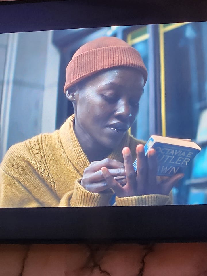 Lupita Nyong'o plays a character surviving an alien attack in NYC and holds Octavia Butler's alien science fiction novel Dawn in her hands.
