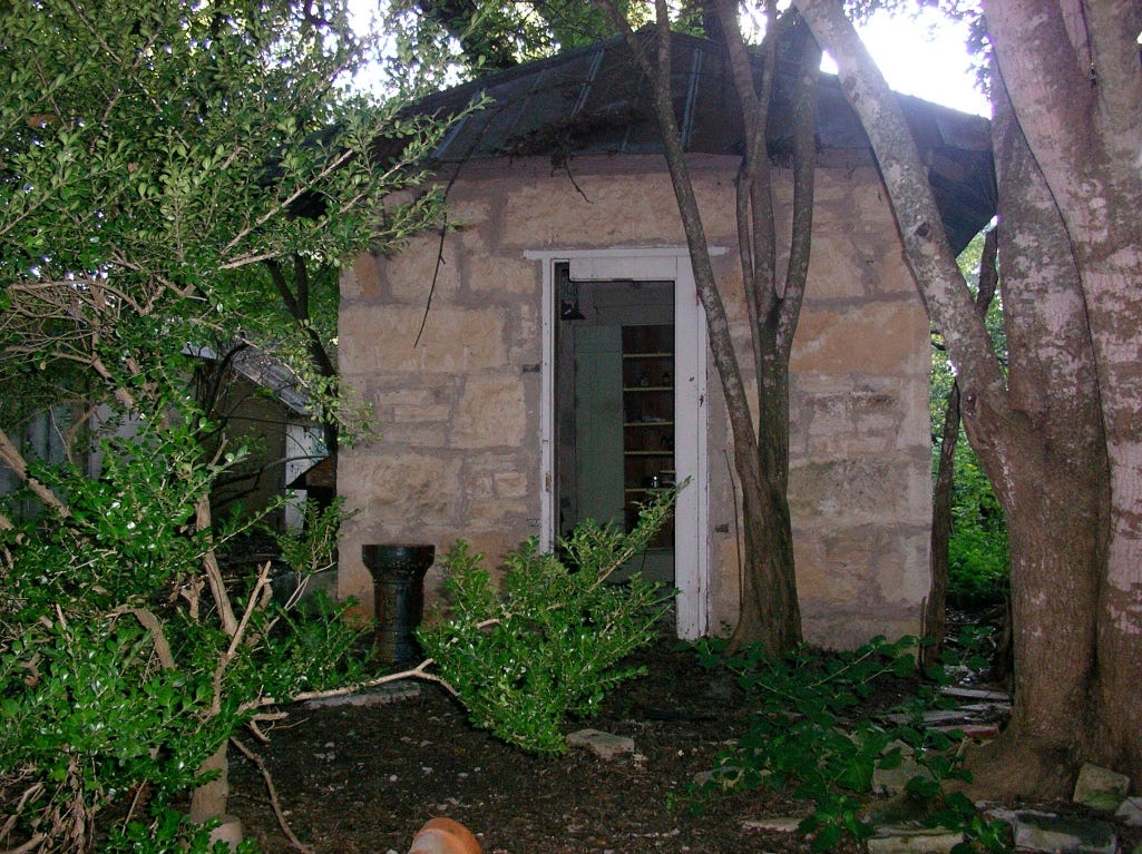 A small stone building surrounded by trees

AI-generated content may be incorrect.