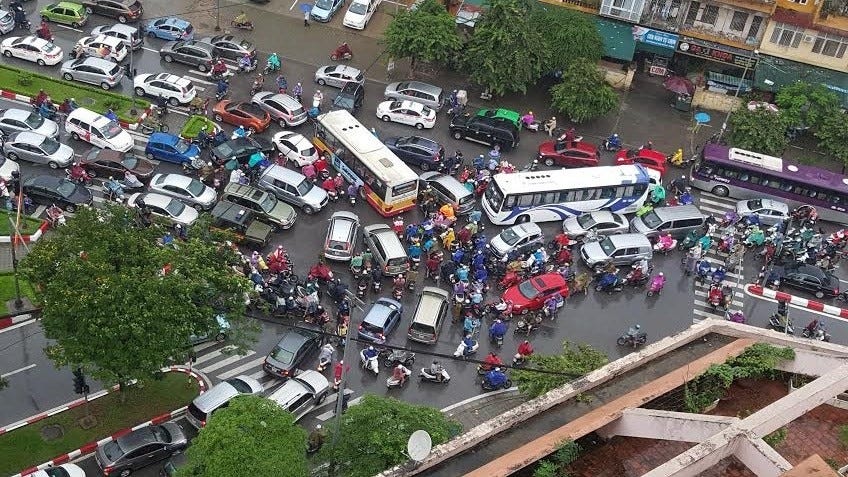 May be an image of car, crowd and text