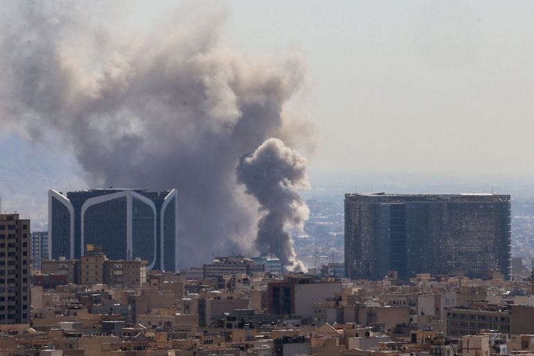 A plume of smoke rises following reported explosions in Tehran A plume of smoke rises following reported explosions in Tehran