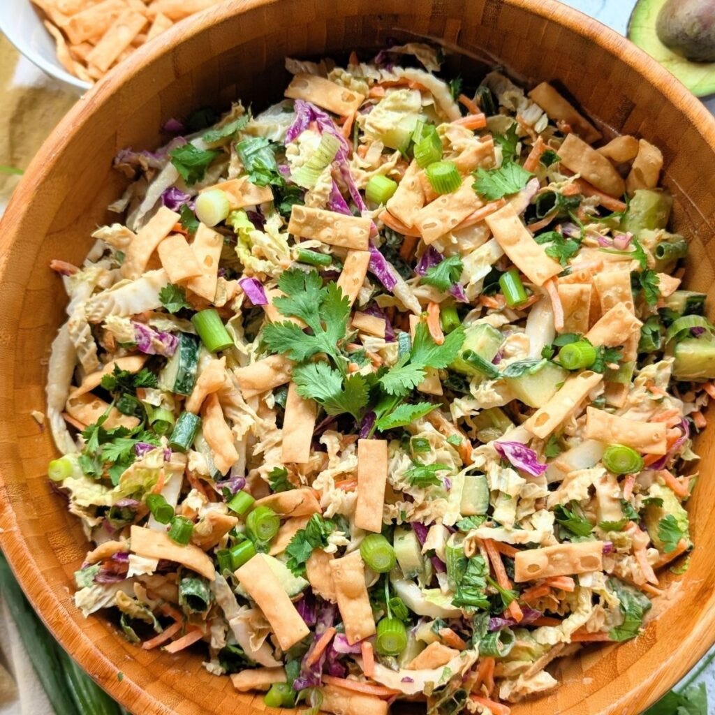 a bowl of cabbage chopped salad with peanut dressing for a copycat recipe