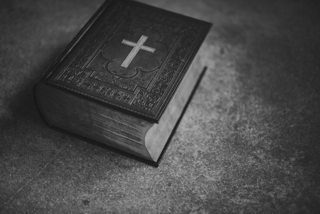black Bible on gray surface
