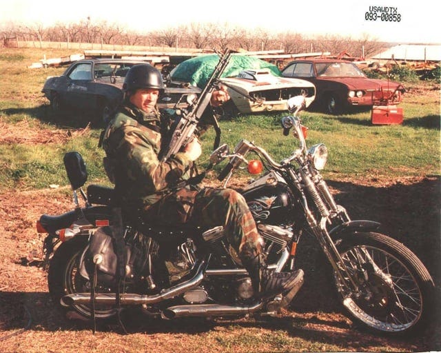 FBI HRT agent armed with an M60E4 GPMG posing with David Koresh's  motorcycle during the aftermath of the Waco Siege : r/ForgottenWeapons