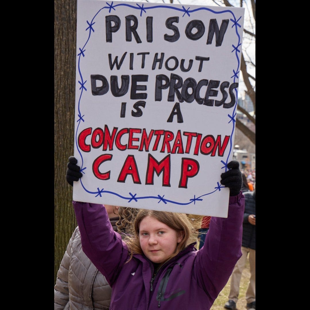 Photo Credit- No Kings, B. Martin, image of girl holding a sign that reads "Prison without due process is a concentration camp."