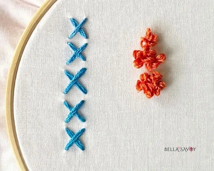 The Cross Stitch & Loop Stitch 60 blue cross stitch on left, orange loop stitch cluster on the right, on hooped fabric