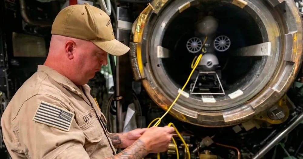 Chief Fire Control Technician Will McCrary checks connections on a Blueye X3 remotely operated vehicle (ROV) before a test launch from a torpedo tube aboard Los Angeles-class fast-attack submarine USS Pasaden. Photo via Petty Officer 2nd Class Mailani Jones-Thornto. Chief Fire Control Technician Will McCrary checks connections on a Blueye X3 remotely operated vehicle (ROV) before a test launch from a torpedo tube aboard Los Angeles-class fast-attack submarine USS Pasaden. Photo via Petty Officer 2nd Class Mailani Jones-Thornto.