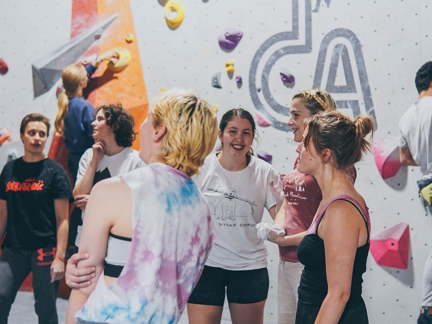 women climbers smiling laughing fun group climb boulder tca prop store