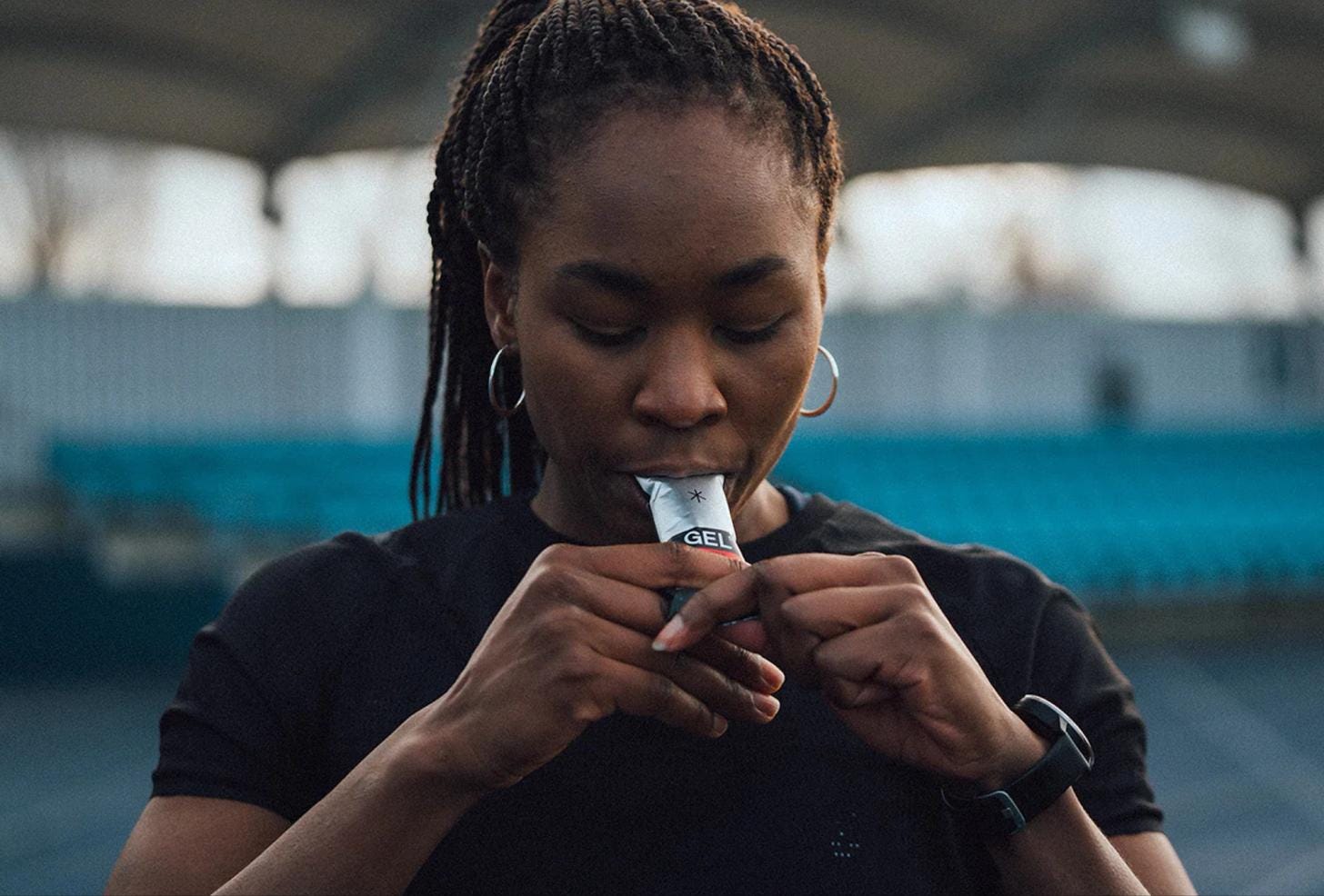 Female athlete drinking an electrolyte beverage during training. Female athlete drinking an electrolyte beverage during training.