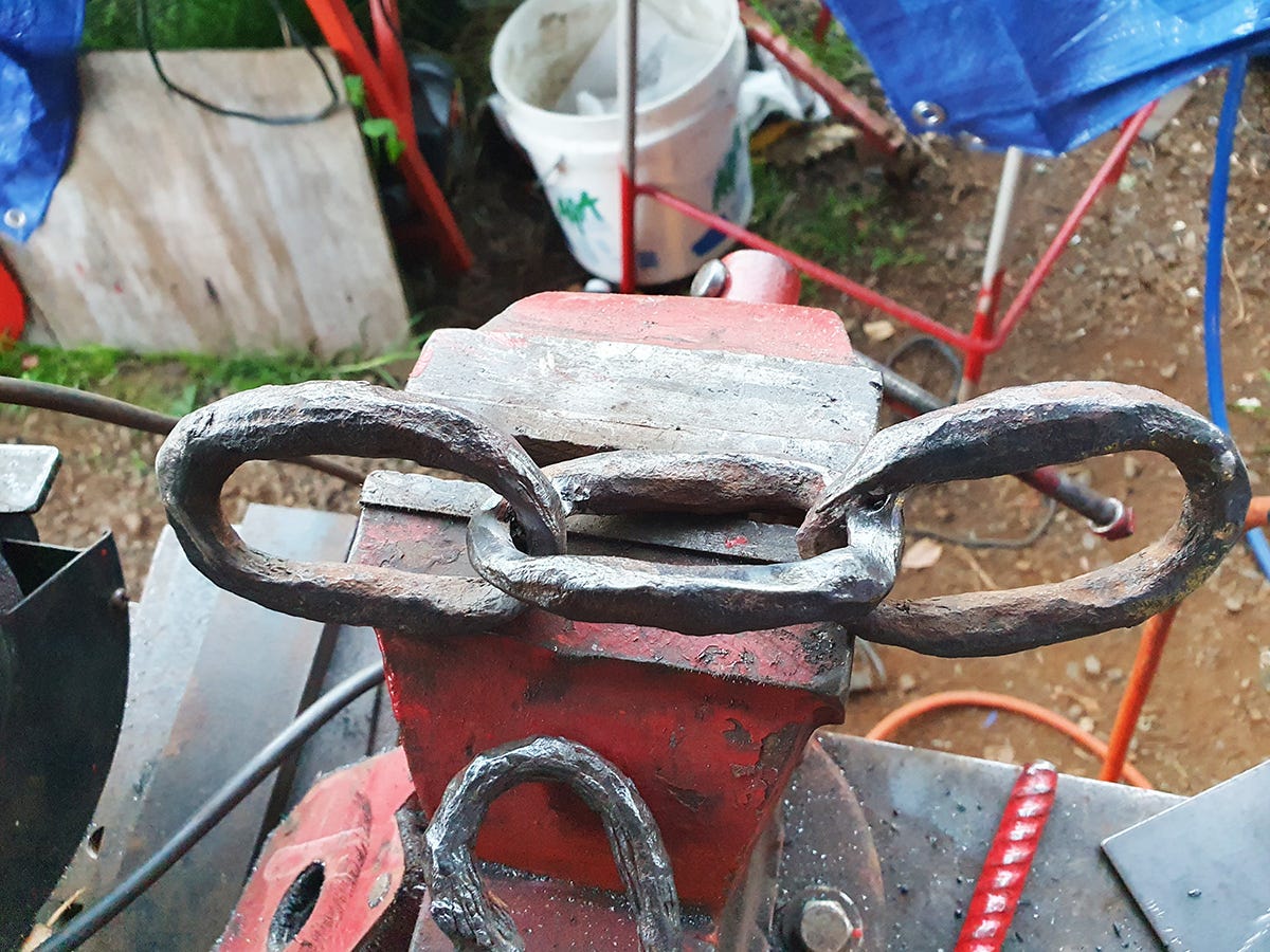 A picture of 3 large link of an old rusty chain welded together by McKinley Rd Creatives. Welding chain is not the easiest thing to accomplish.