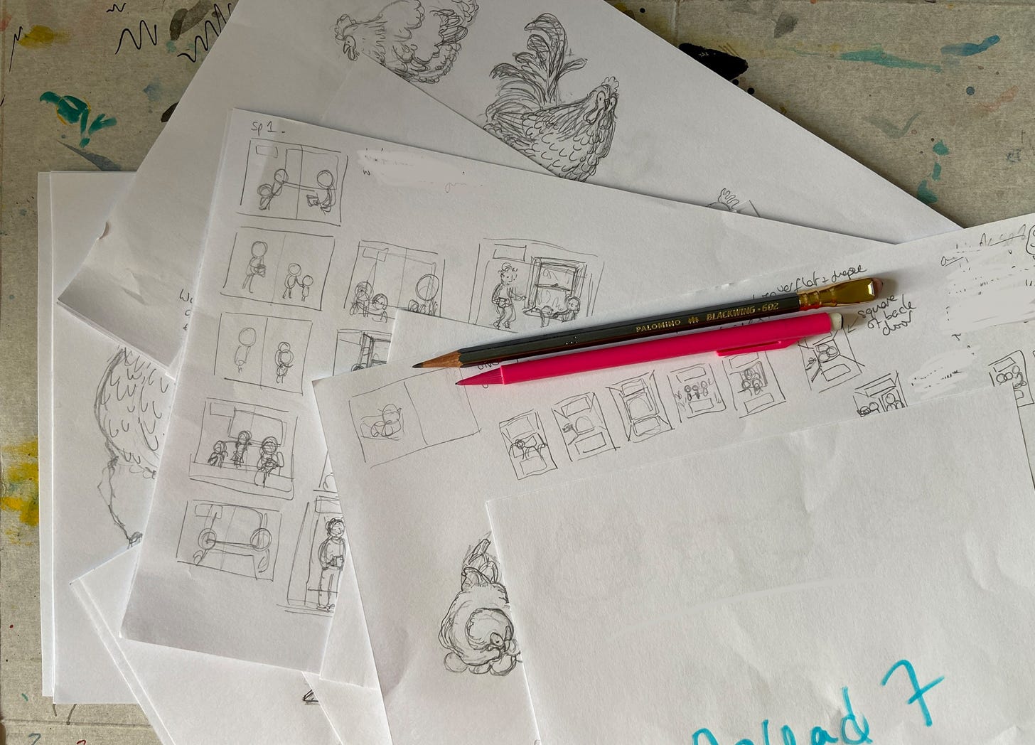 An untidy pile of A4 paper with small rough sketches some chickens and some layout compositions. A blackwing pencil and pink mechanical pencil are on top of the papers