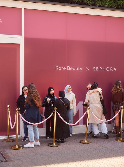Photos of a maroon Clinique van in Covent Garden and lines of people queuing.