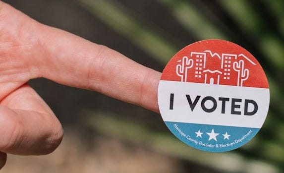 person holding red and white round pin person holding red and white round pin