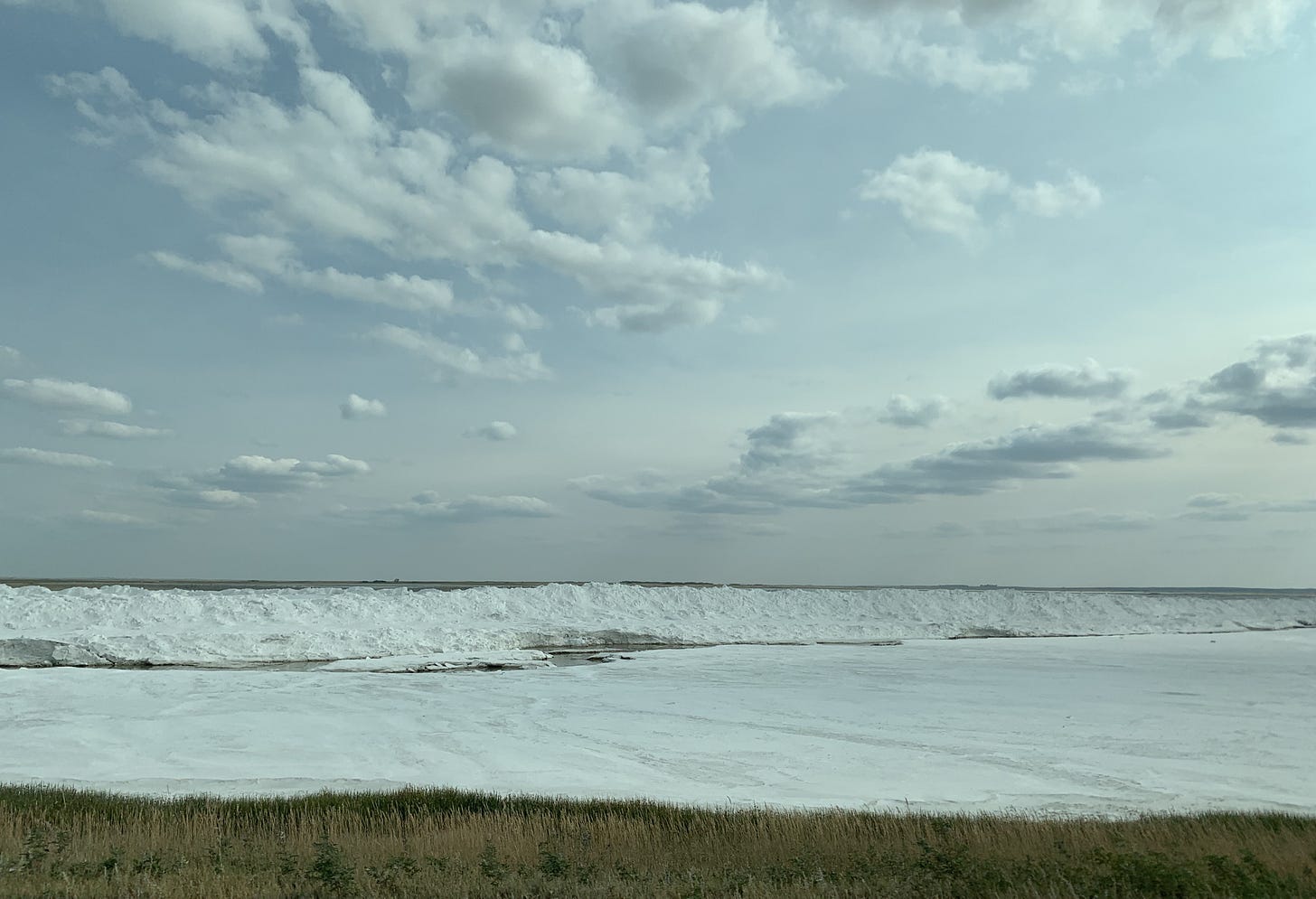 The shore of Chaplin Lake, Saskatchewan, with piles of extracted salt.