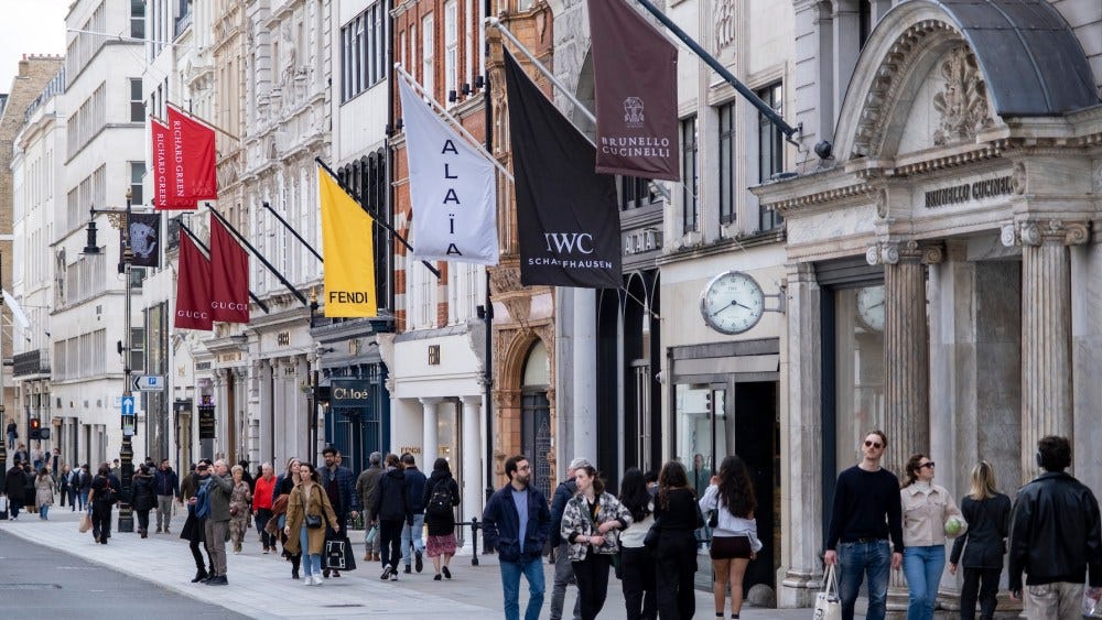 Art gallery and fashion retailers flags on Bond Street in London, United Kingdom. Bond Street is one of the principal streets in the West End shopping district and is very upmarket. It has been a fashionable shopping street since the 18th century.