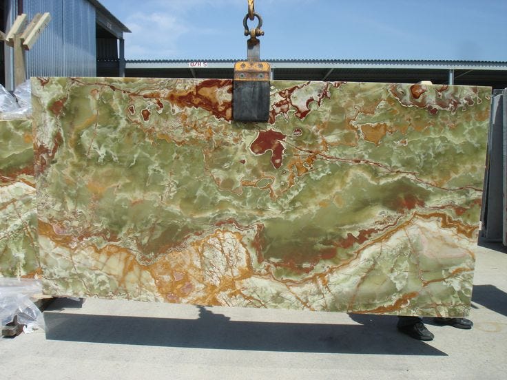 This may contain: a large green marble slab sitting on top of a dolly