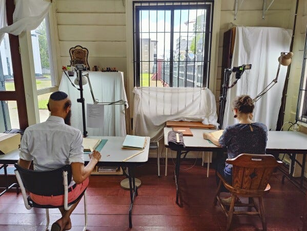 CORRECTS THE NAME - Ronny Reeder, left, and Rosa de Jong scan images in Paramaribo, Suriname, Friday, May 2, 2025. (AP Photo/Oscar Keur)