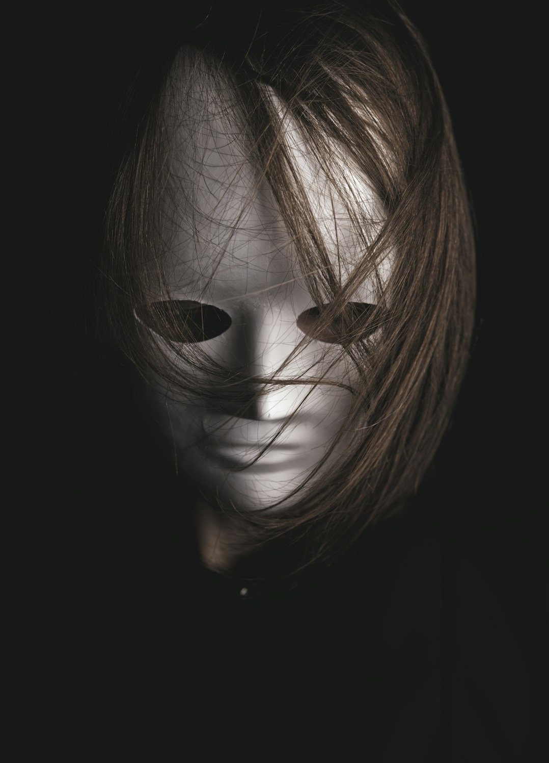 woman with brown hair covering her face