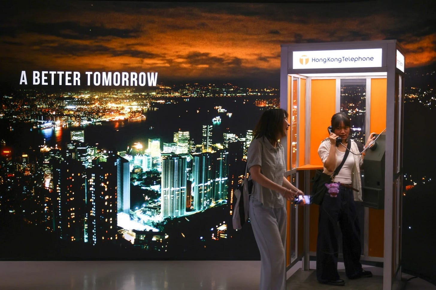 Visitors use a telephone booth at the exhibition. Photo: Eugene Lee