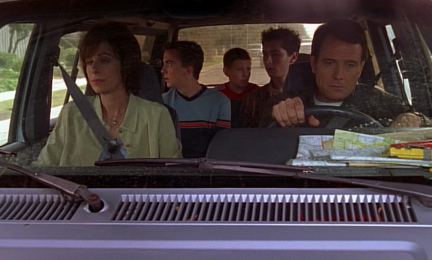 An image from the original Malcolm in the Middle: Hal and Lois are in the front seat of a car with their three sons in the backseat An image from the original Malcolm in the Middle: Hal and Lois are in the front seat of a car with their three sons in the backseat