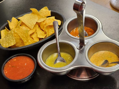 Tacos la Familia chips and salsa trio, chicken burrito, and birria tacos