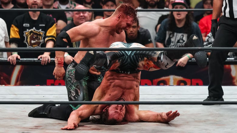 Will Ospreay performing the Tiger Driver '91 on Kenny Omega
