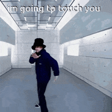 a man in a top hat is dancing in a room with the words " i 'm going to touch you " on the bottom