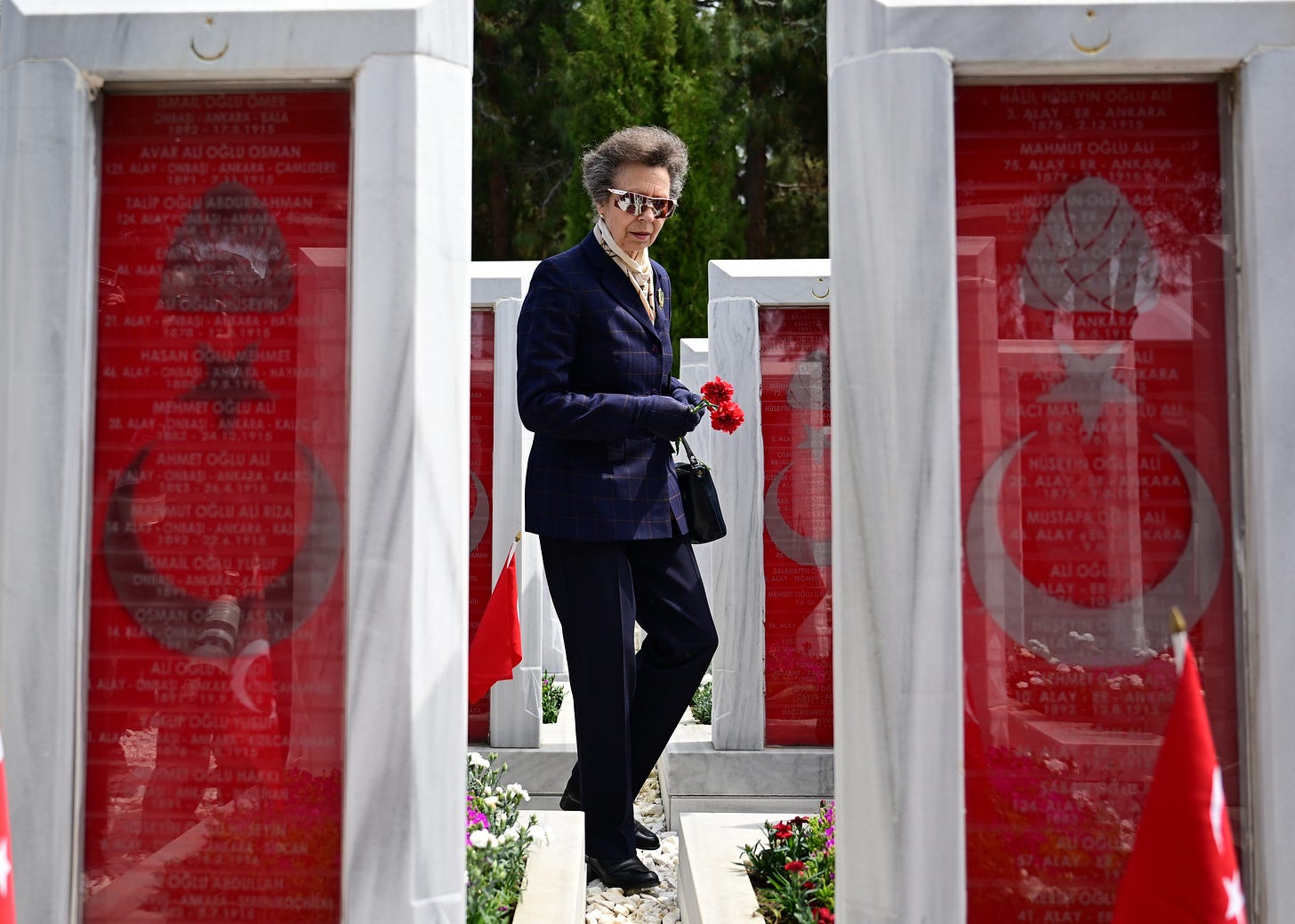 Princess Anne placing flowers at graves in Turkey