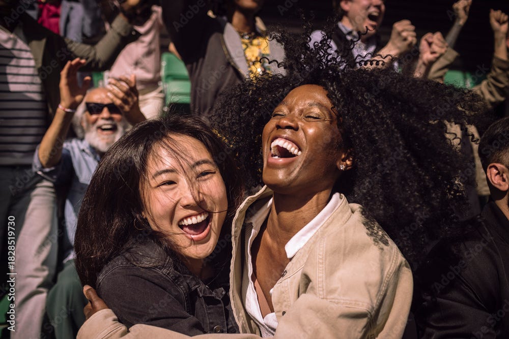 Carefree female friends celebrating with each other in stadium stand on game day Carefree female friends celebrating with each other in stadium stand on game day