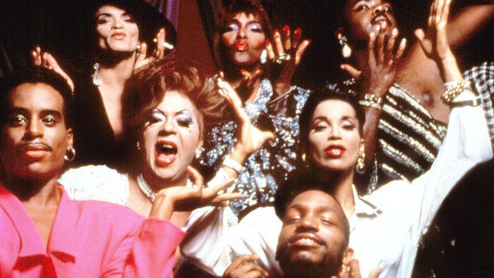 This photo stems from a documentary entitled “Paris is Burning” which revolves around the ballroom scene. It focuses on the specific experiences of Black and Brown men as well as transgender women. The purpose of the documentary was to provide information on the club and ballroom scene and to open the eyes of straight audience members to depict the struggles faced by members of the LGBTQ community. (Image Source: Academy Entertainment) This photo stems from a documentary entitled “Paris is Burning” which revolves around the ballroom scene. It focuses on the specific experiences of Black and Brown men as well as transgender women. The purpose of the documentary was to provide information on the club and ballroom scene and to open the eyes of straight audience members to depict the struggles faced by members of the LGBTQ community. (Image Source: Academy Entertainment)