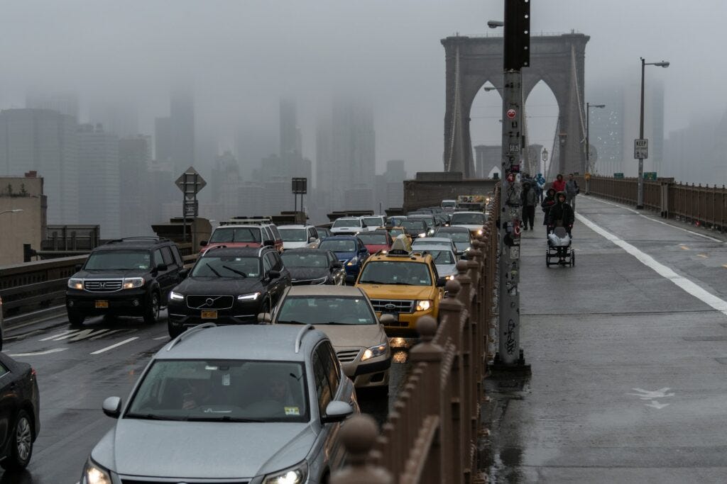 Rainy day traffic on Brooklyn Bridge.