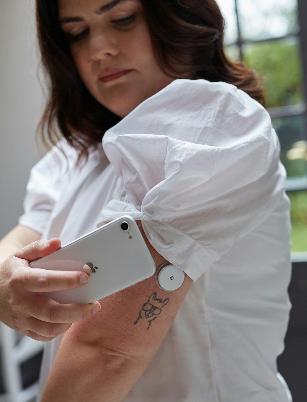 a person scanning blood glucose with a flash glucose monitor a person scanning blood glucose with a flash glucose monitor