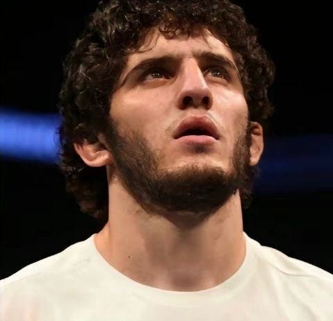 This may contain: a man with curly hair and beard wearing a white shirt This may contain: a man with curly hair and beard wearing a white shirt