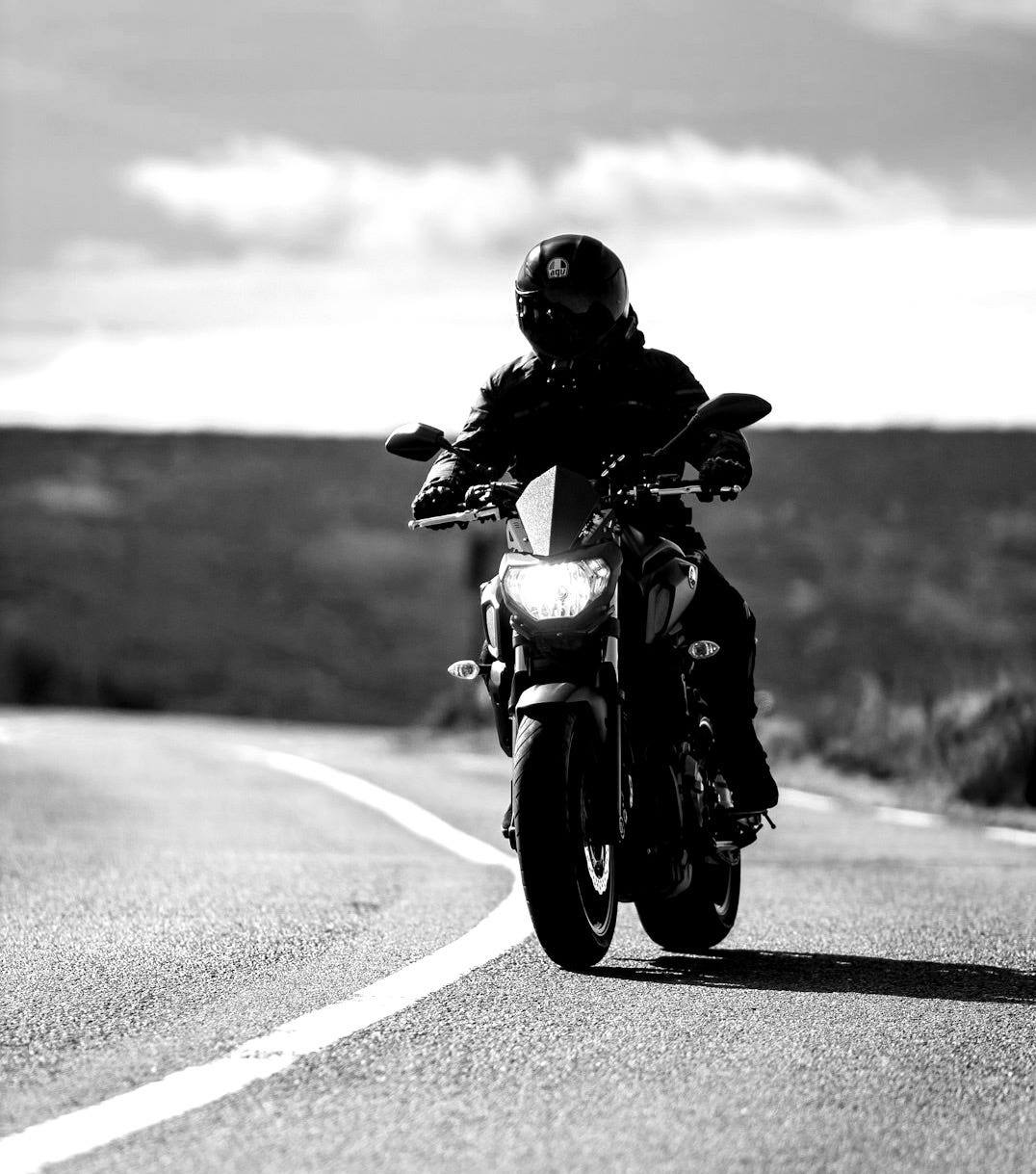 a person riding a motorcycle on a road a person riding a motorcycle on a road