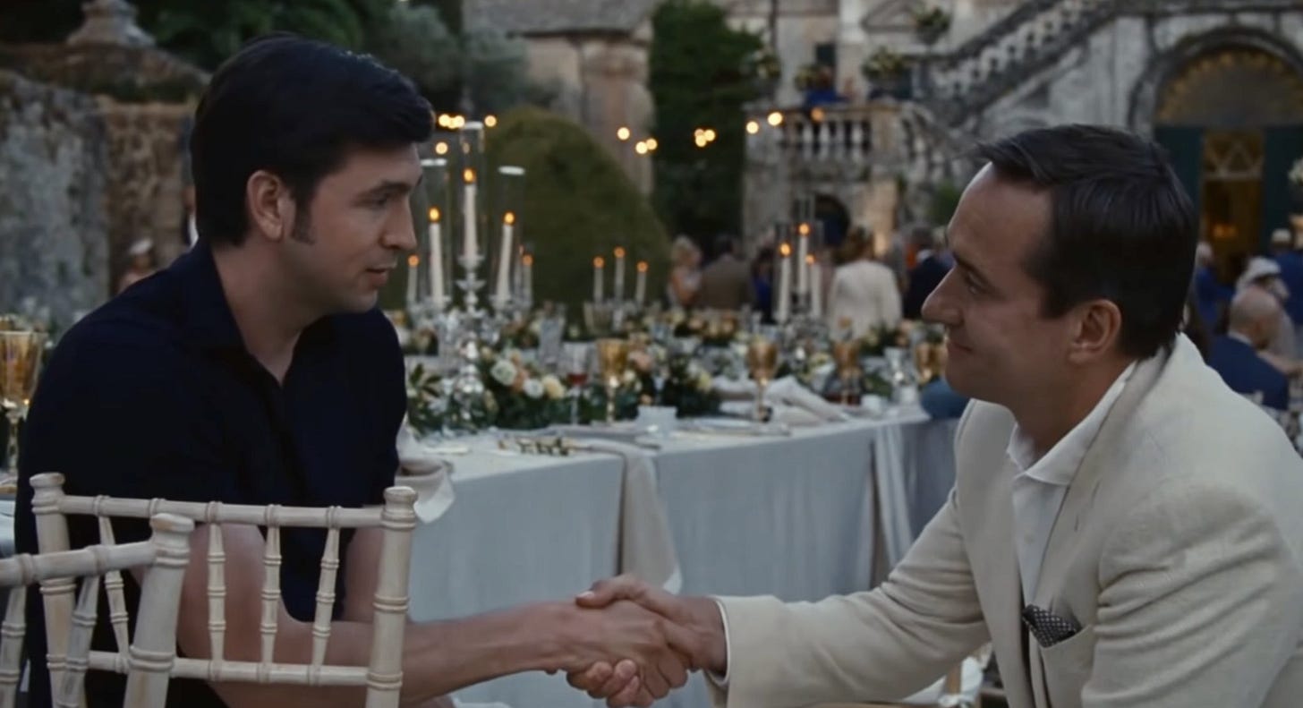 Two men shaking hands at an outdoor dinner table, symbolizing informal startup funding agreements.