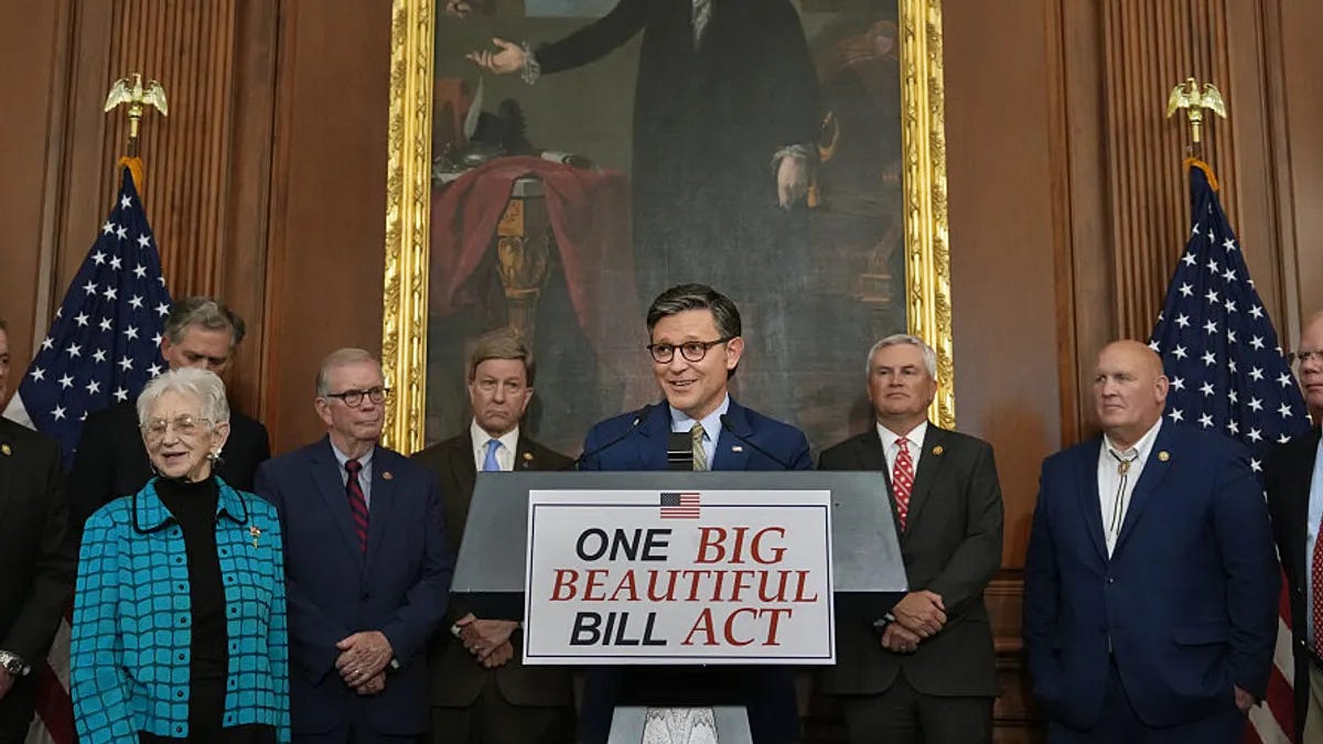 Speaker Mike Johnson stands behind a podium in front of a portrait of George Washington.