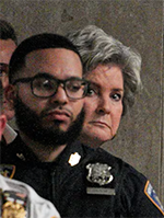 Susie Wiles peering over shoulder of police officer Susie Wiles peering over shoulder of police officer