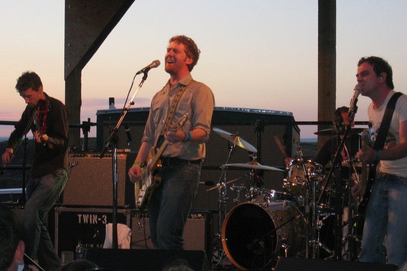 The Frames performing on an outdoor festival stage. The Frames performing on an outdoor festival stage.