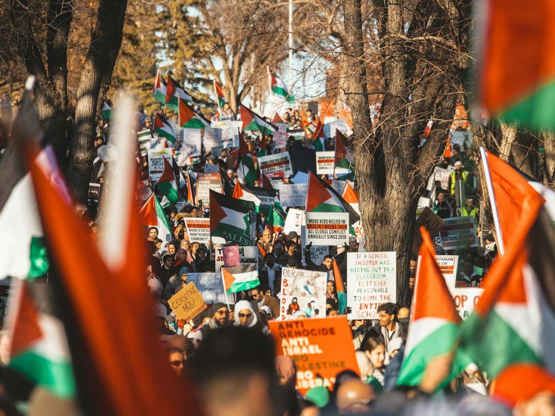a crowd of people holding orange and green flags a crowd of people holding orange and green flags