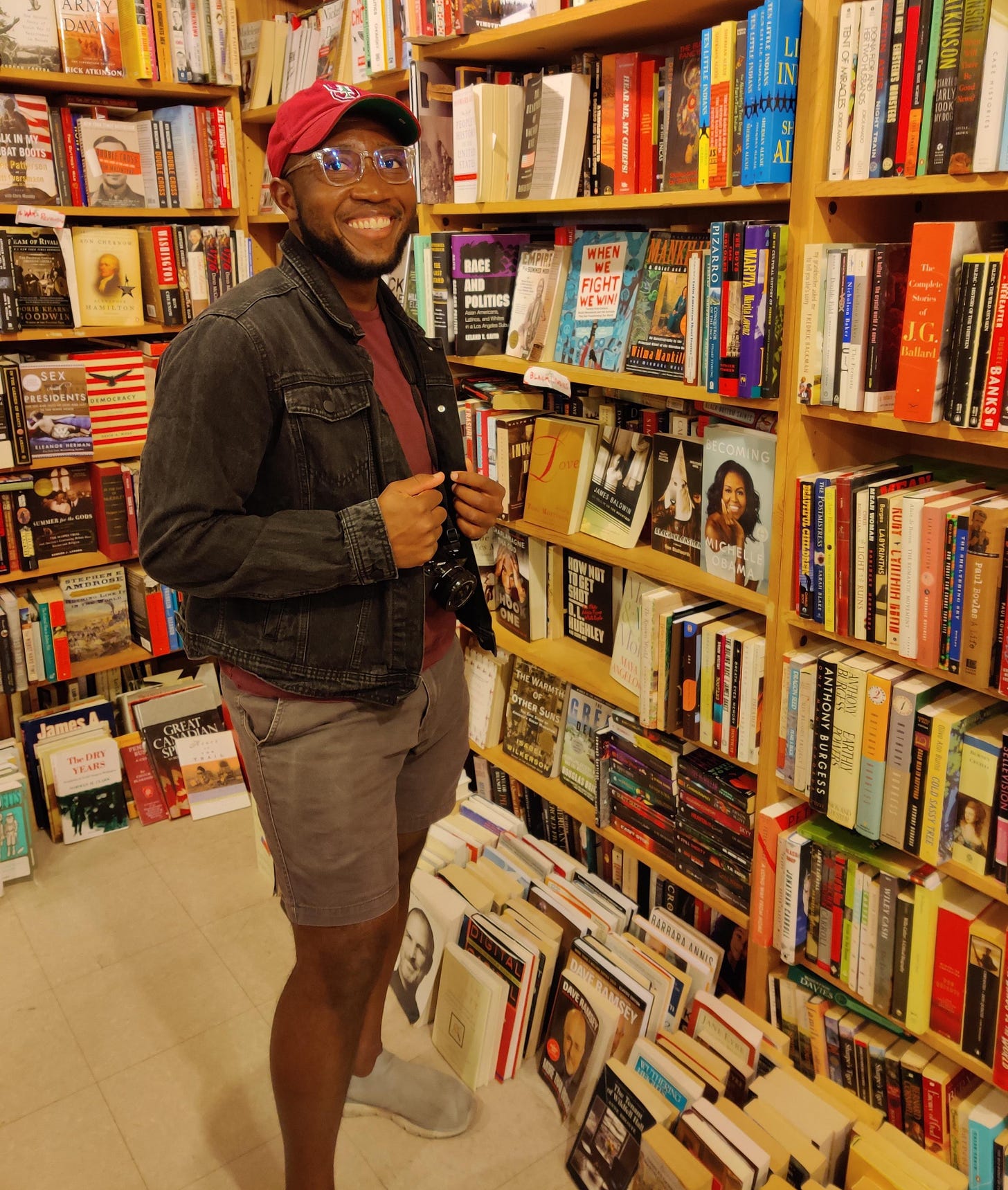 Awoe standing in a bookstore