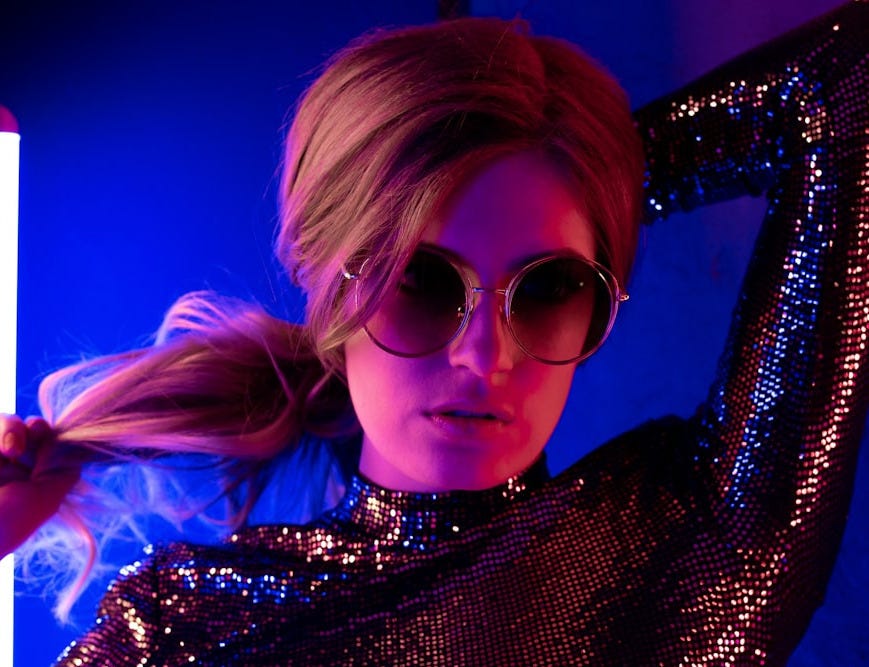 woman in black and white polka dot shirt wearing sunglasses woman in black and white polka dot shirt wearing sunglasses