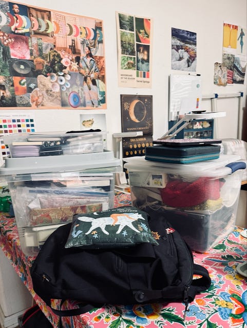  Clear plastic storage boxes containing colorful fabric swatches, books, and various art supplies